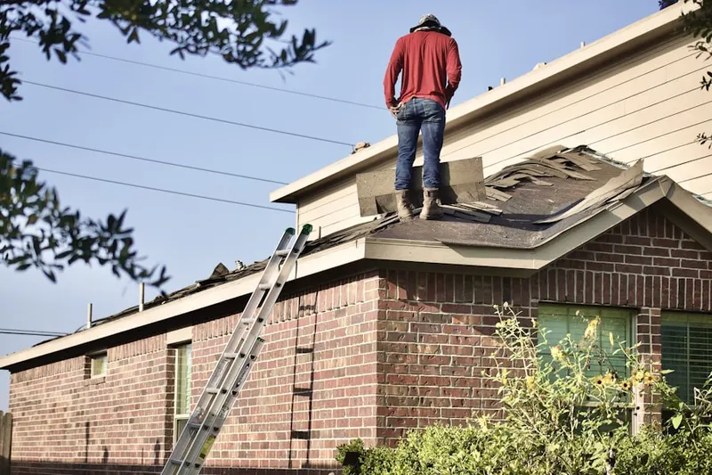 Professional roofer working on a residential roof in Tropico